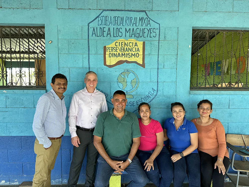 Crossroads leaders gather outside a school during an international visit.