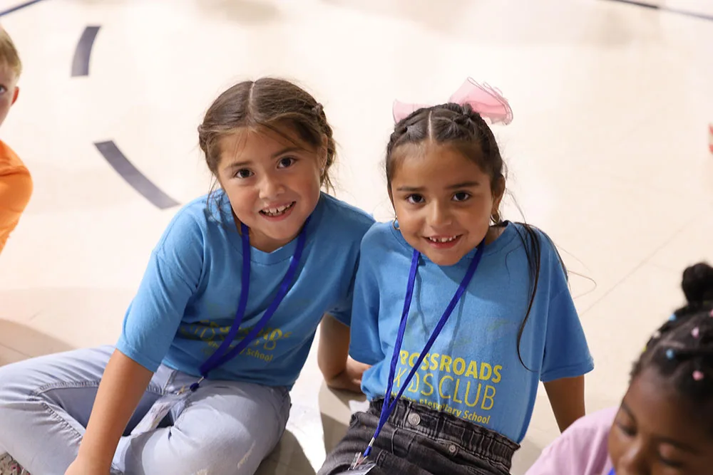 give-60-two-children Two girls smile together during Crossroads Kids Club.