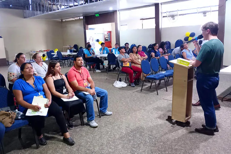 A Crossroads leader presents to adults at a club-launch meeting.
